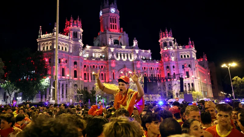 Na znamenitem madridskem trgu de Cibeles so bučno in množično pospremili veliki finale evropskega prvenstva v nogometu. FOTO: Isabel Infantes/Reuters