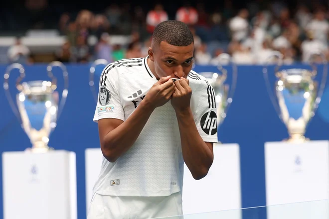 Kylian Mbappe je poljubil grb novega dresa. FOTO: Pierre-Philippe Marcou/AFP