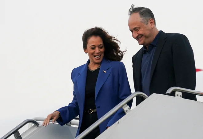 Kamala Harris in njen soprog Doug Emhoff po prihodu v Chicago, kjer poteka tokratna demokratska konvencija. FOTO:  Kevin Lamarque/Reuters