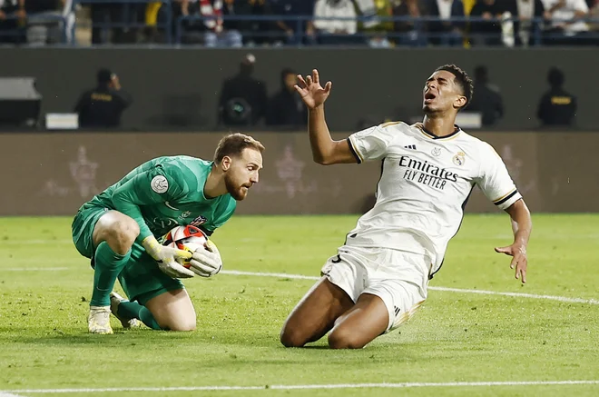 Jan Oblak je že znal ukrotiti Juda Bellinghama, ki ga na petih tekmah še ni premagal. FOTO: Juan Medina/Reuters