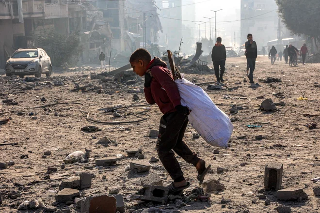 Izraelske sile po sredinem dogovoru s palestinskim gibanjem Hamas o prekinitvi ognja nadaljujejo napade na Gazo. Medtem ko so Palestinci proslavljali dogovor, je bilo v obstreljevanju v sredo zvečer v Gazi ubitih 32 ljudi. FOTO: Omar Al-qattaa/AFP