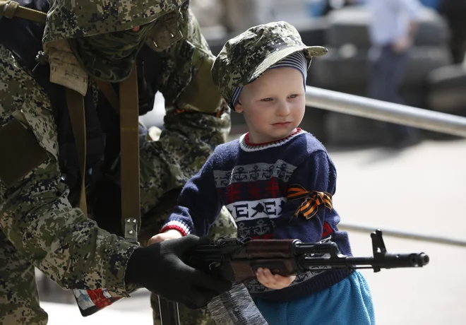 Orožje je biznis, krepi BDP, posredno standard volivcev, pa še za našo varnost je menda uporabno.

Na fotografiji: pripadnik proruskih separatistov z otrokom 28. aprila 2014 mestu Kostiantinivka v regiji Donetsk na vzhodu Ukrajine, ko so proruski separatisti zavzeli policijsko postajo. Foto Marko Djurica/Reuters