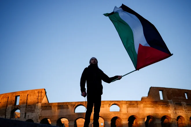 Medtem ko je policistka fotografirala moj osebni dokument, mi je taisti policist v civilu izročil zastavo. Bila sem srečna, zahvalila sem se mu in rekla: »Danes je to drugič, da mi je policija rešila palestinsko zastavo!« FOTO: Guglielmo Mangiapane/Reuters