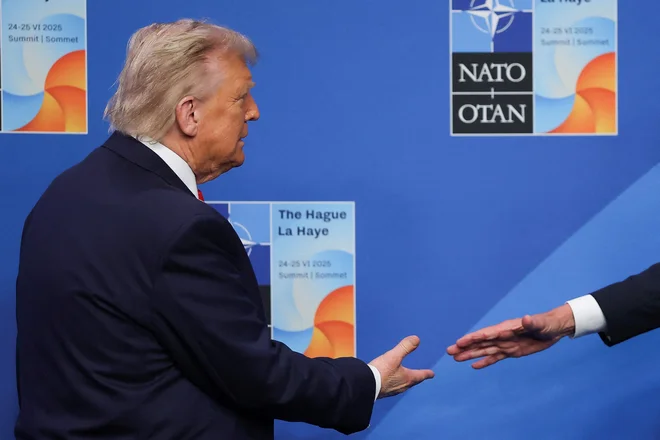 Generalni sekretar Nata Mark Rutte (desno) se rokuje z ameriškim predsednikom Donaldom Trumpom. FOTO: Christian Hartmann/AFP